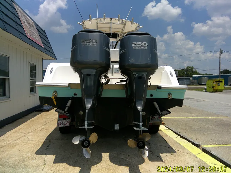 Slide: The Image of 2006 McKee Craft FREEDOM TE 28 boat with dual 250 horsepower engines, parked outdoors. - 9