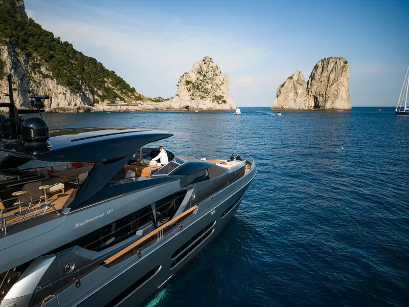 Slide: The Image of Luxury Posillipo Technema 90 yacht cruising near rocky coastline, 2024 model. - 1
