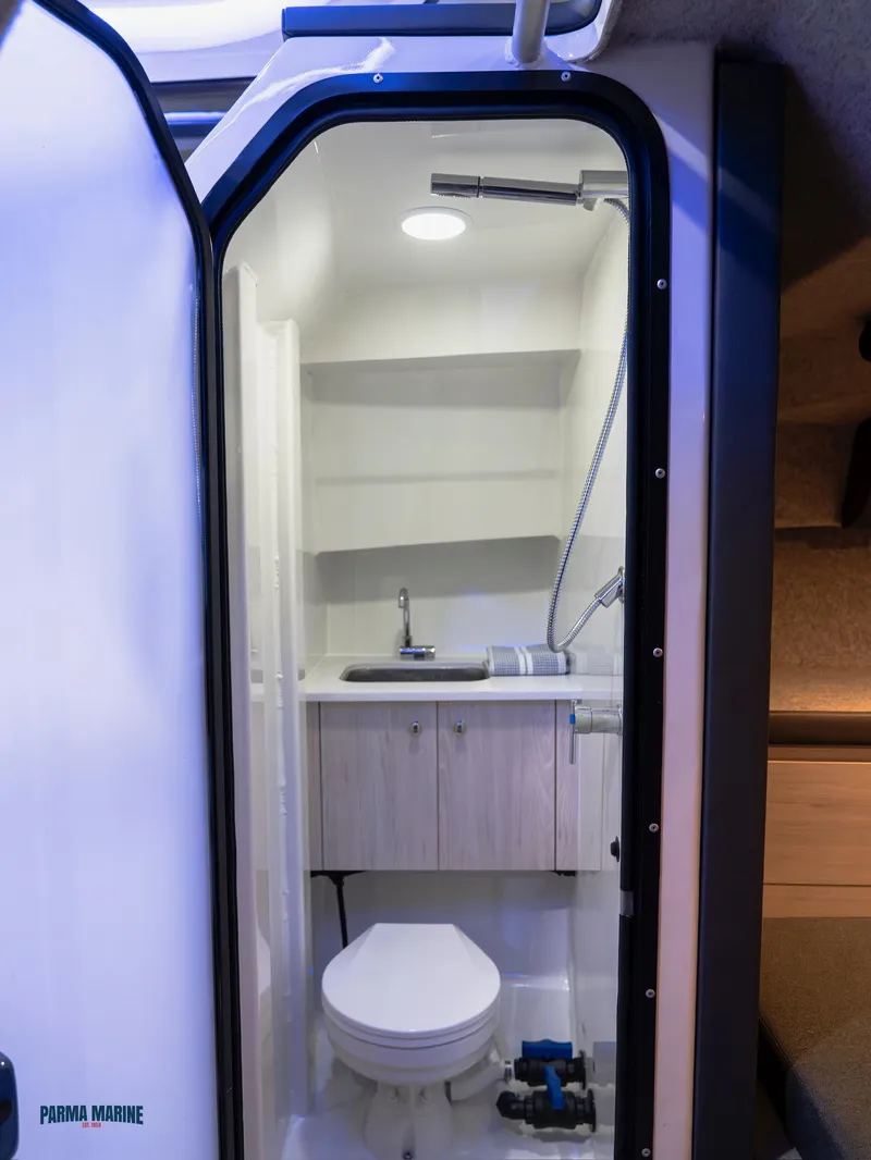 Slide: The Image of 2025 Extreme Boats 986 Game King helm with navigation display and controls. - 18