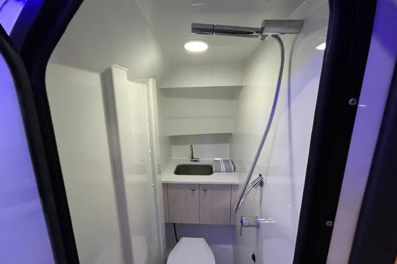 Slide: The Image of 2025 Extreme Boats 986 Game King bathroom with shower, sink, and modern fixtures. - 21