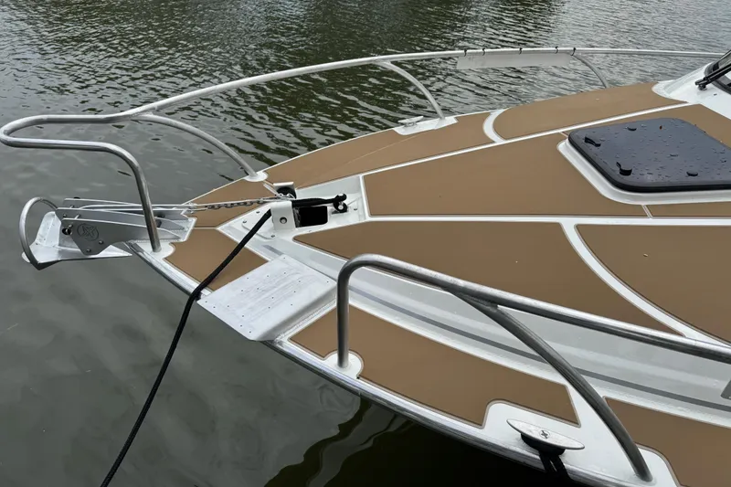 Slide: The Image of 2025 Extreme Boats 986 Game King bow with anchor, on calm water. - 4