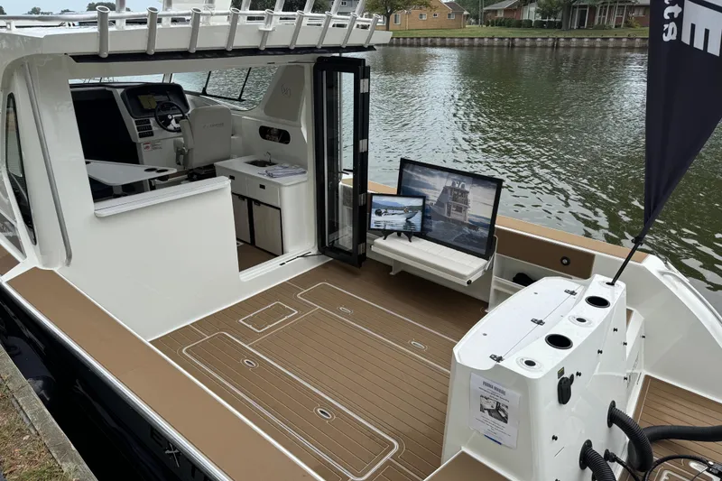 Slide: The Image of 2025 Extreme Boats 986 Game King with spacious deck and modern interior on a calm waterway. - 6