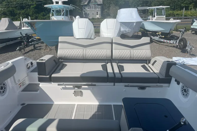 Slide: The Image of 2026 Monterey Elite 30 OB boat interior with gray seating and modern design. - 14