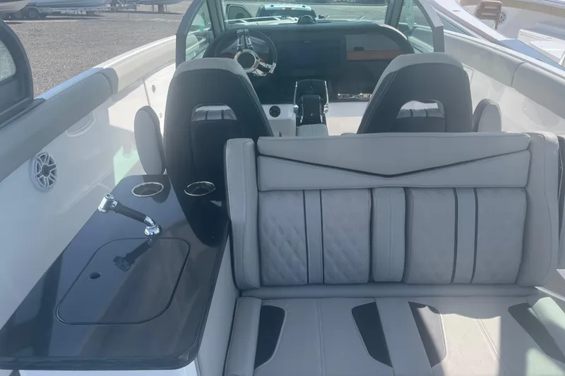 Slide: The Image of 2026 Monterey Elite 30 OB boat interior with sleek seating and modern dashboard. - 15