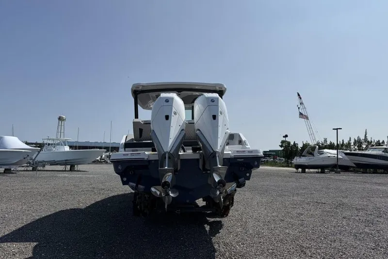 Slide: The Image of 2026 Monterey Elite 30 OB boat on trailer in sunny outdoor setting. - 5