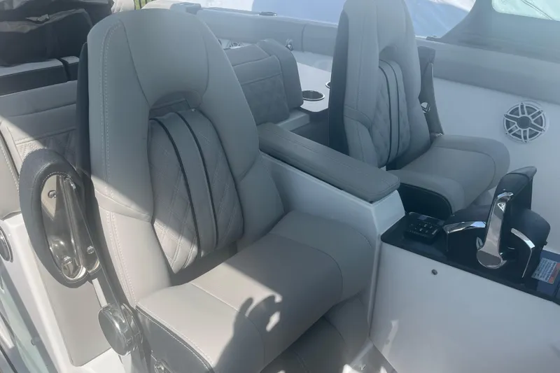 Slide: The Image of 2026 Monterey Elite 30 OB boat with dual outboard engines in a marina setting. - 7