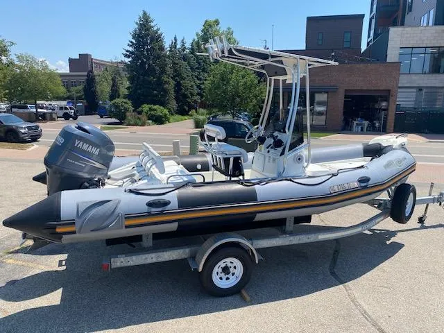 The Image of 2011 Zodiac Pro Open 650 boat on trailer, parked outdoors with Yamaha engine. - 0