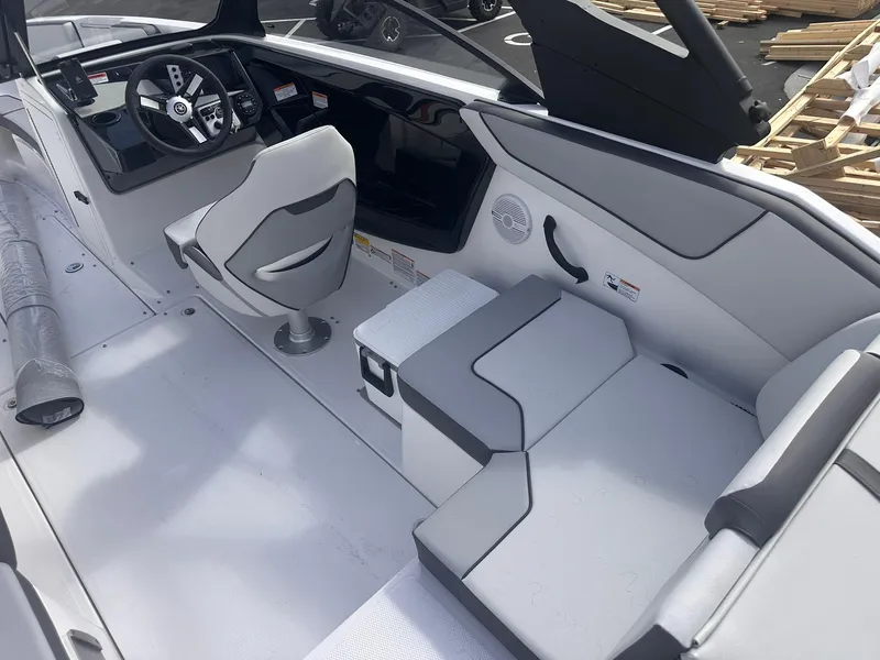 Slide: The Image of 2025 Yamaha Boats AR220 interior with steering wheel, seating, and dashboard controls. - 10