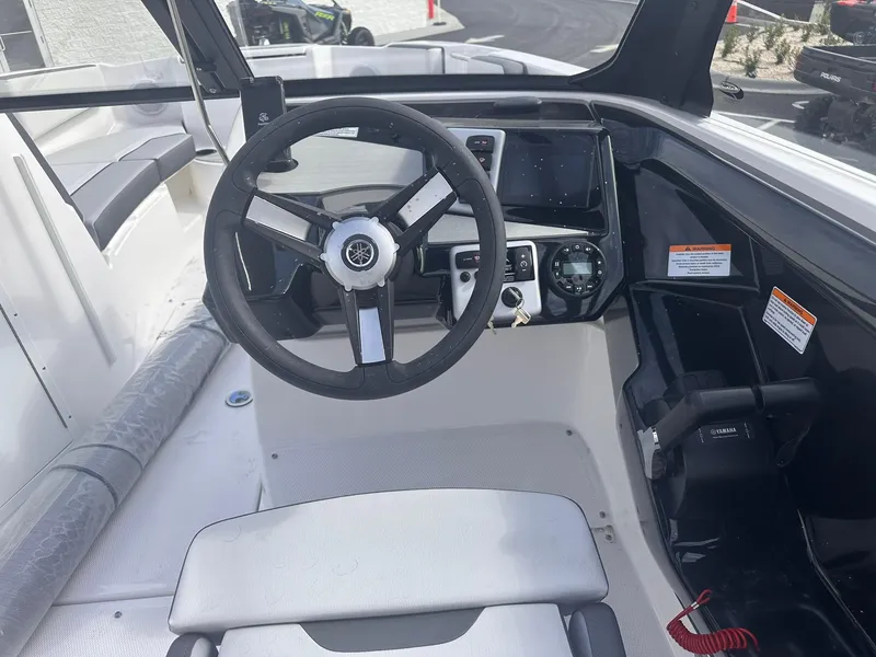 Slide: The Image of 2025 Yamaha Boats AR220 cockpit with steering wheel and control panel. - 13