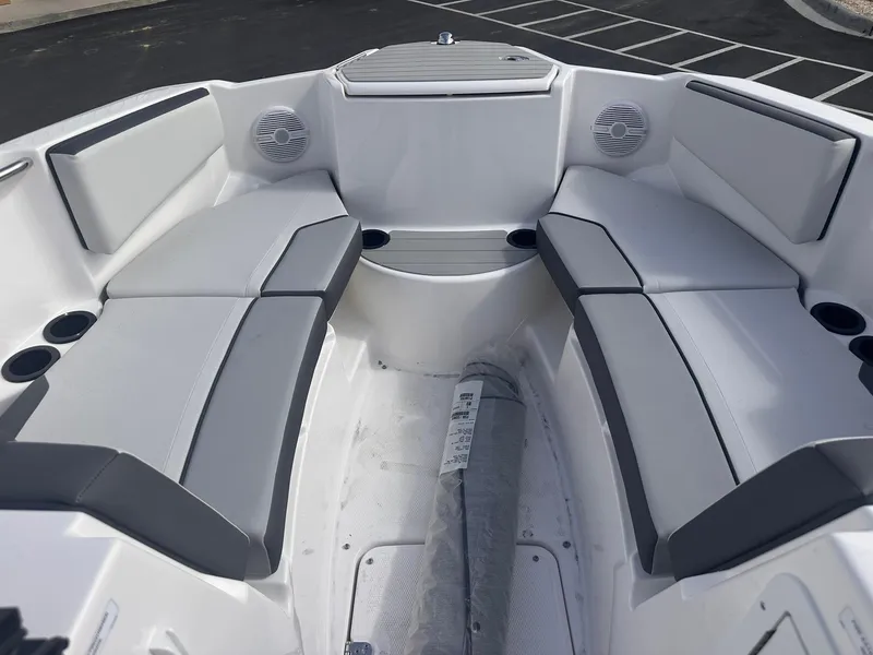 Slide: The Image of 2025 Yamaha Boats AR220 interior with gray seating and cup holders. - 15