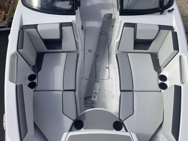 Slide: The Image of 2025 Yamaha Boats AR220 interior with gray seating and cup holders, top view. - 17
