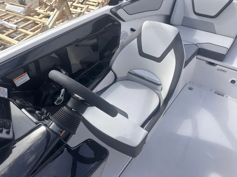 Slide: The Image of 2025 Yamaha Boats AR220 cockpit with sleek steering and modern seating design. - 20