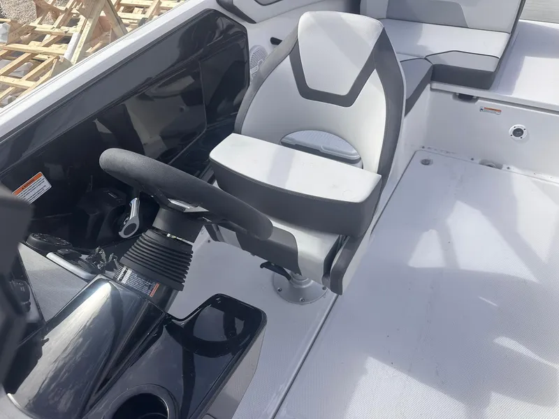 Slide: The Image of 2025 Yamaha Boats AR220 cockpit with steering wheel and captain's chair. - 21