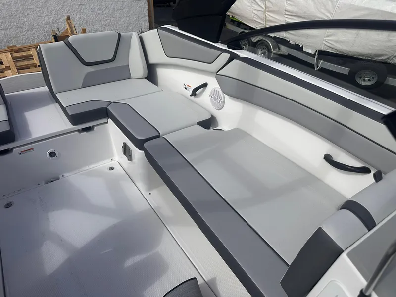 Slide: The Image of 2025 Yamaha Boats AR220 interior seating with gray upholstery and modern design. - 22