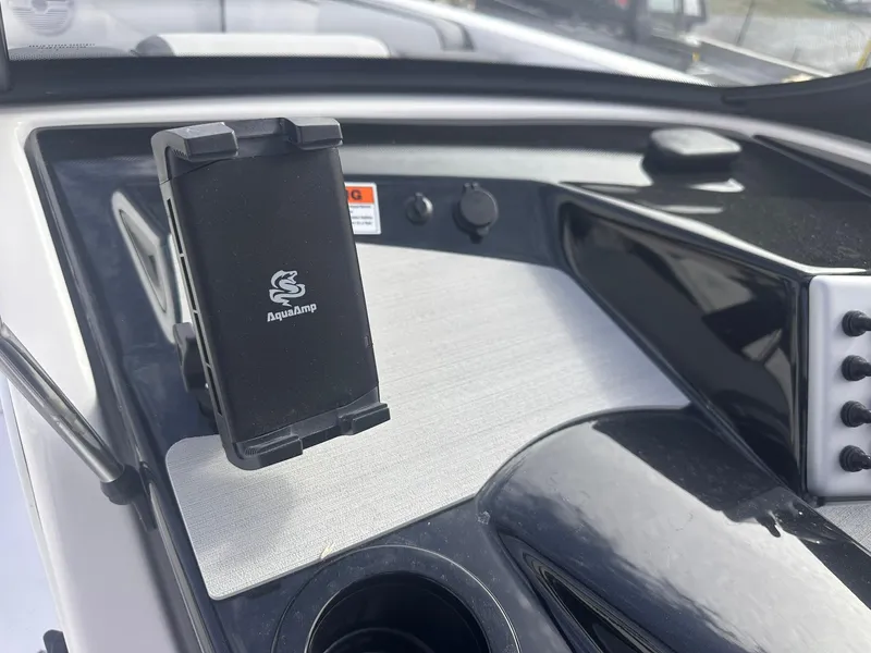 Slide: The Image of Dashboard of 2025 Yamaha AR220 boat with AquaAmp device holder. - 25