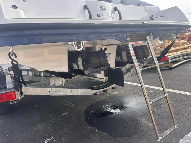 Slide: The Image of 2025 Yamaha Boats AR220 rear view with ladder and trailer. - 26