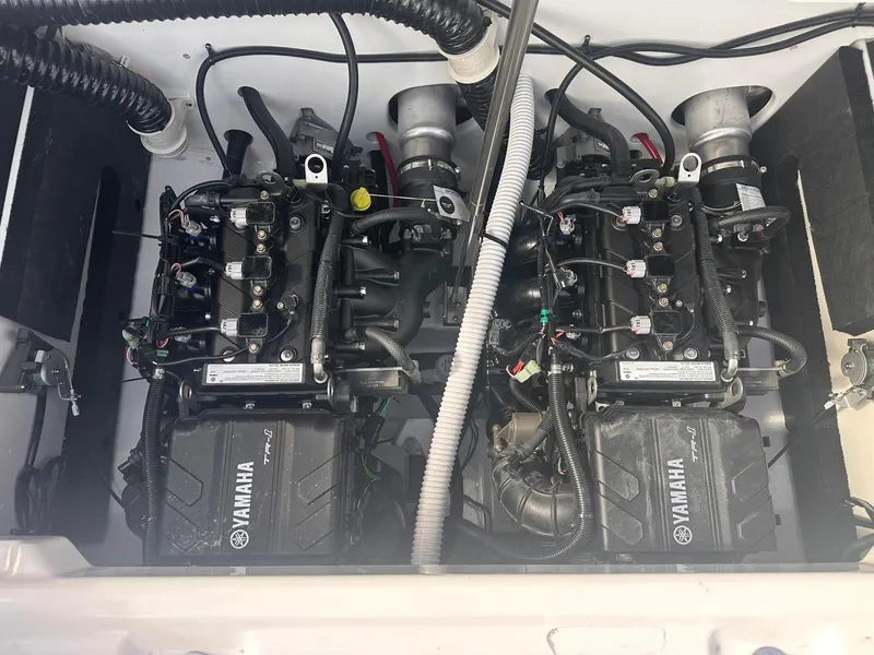 Slide: The Image of 2025 Yamaha Boats AR220 engine compartment with dual engines and wiring. - 31