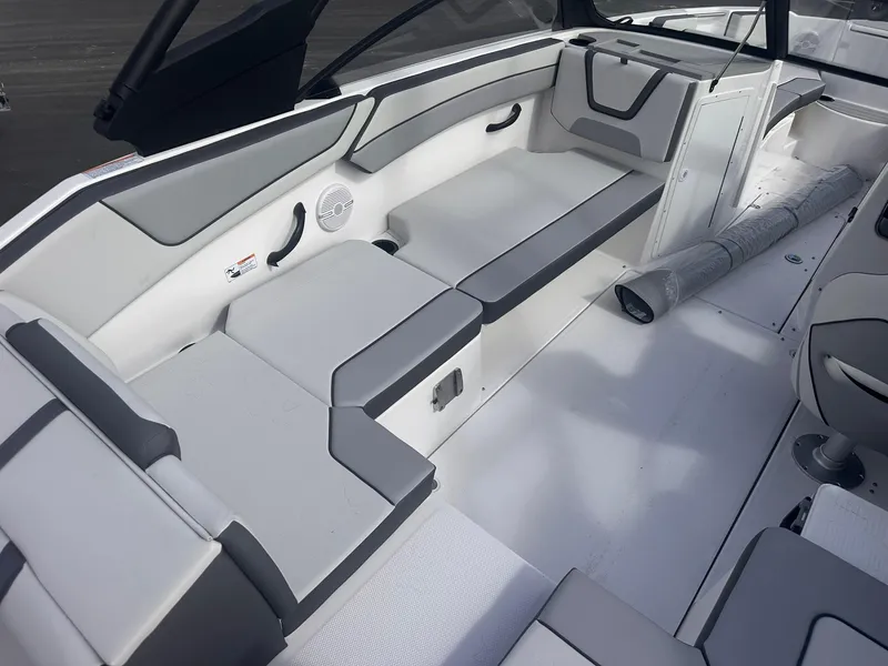 Slide: The Image of 2025 Yamaha Boats AR220 interior with gray seating and storage compartments. - 9