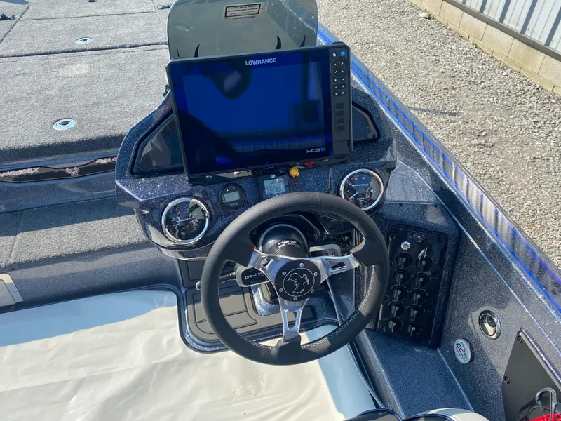 Slide: The Image of 2026 Phoenix 921 2 Elite X boat dashboard with steering wheel and Lowrance display. - 11