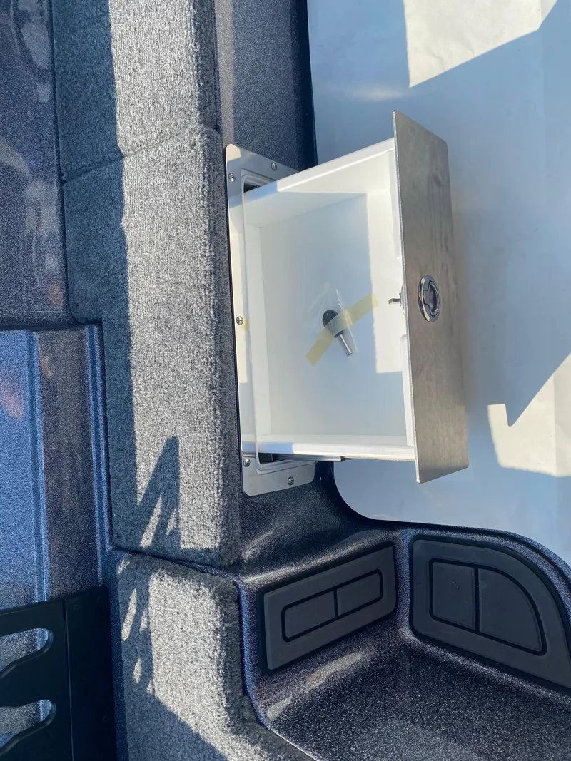 Slide: The Image of Open storage compartment in 2026 Phoenix 921 2 Elite X boat interior. - 14