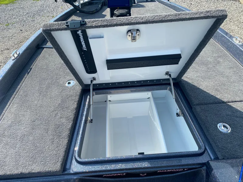 Slide: The Image of Open storage compartment on 2026 Phoenix 921 2 Elite X boat, showing interior details. - 16