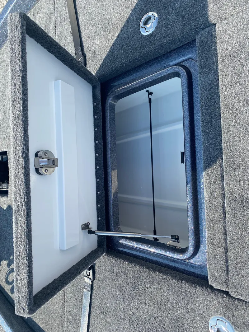 Slide: The Image of Open storage compartment on a 2026 Phoenix 921 2 Elite X boat. - 17