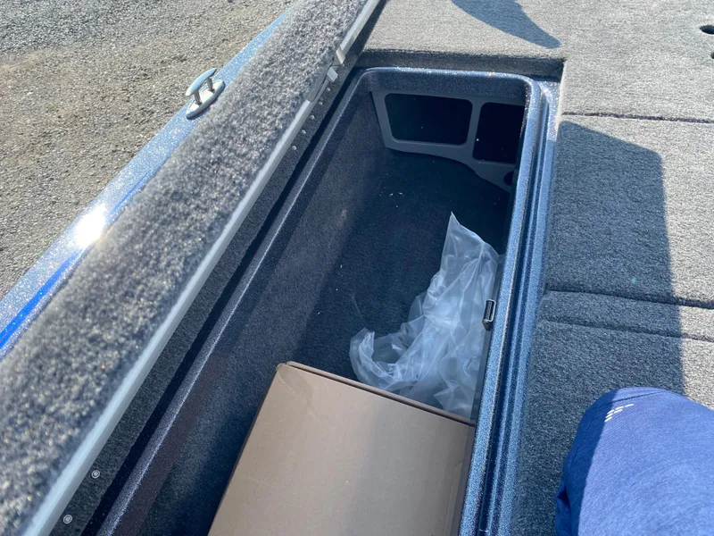 Slide: The Image of Open storage compartment in 2026 Phoenix 921 2 Elite X boat, showing interior space. - 21