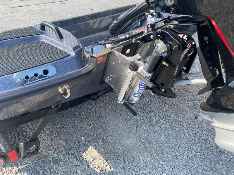 Slide: The Image of Phoenix 921 2 Elite X 2026 boat with hydraulic jack plate on gravel surface. - 5