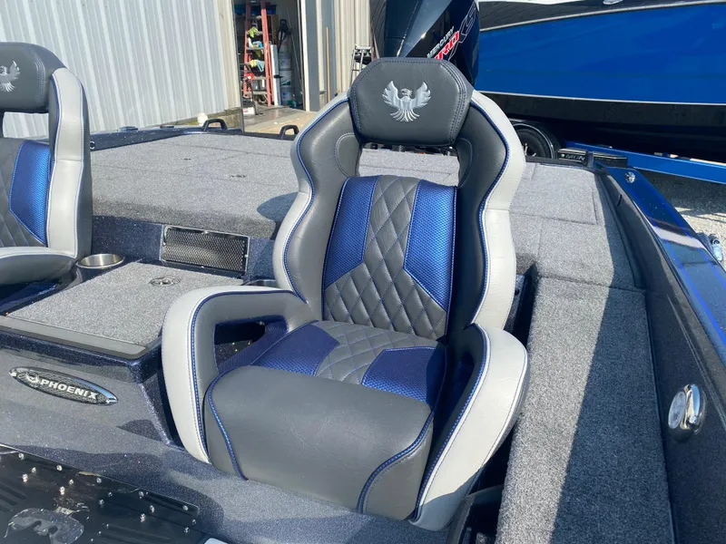 Slide: The Image of Luxury seating in a 2026 Phoenix 921 2 Elite X boat, featuring blue and gray upholstery. - 8
