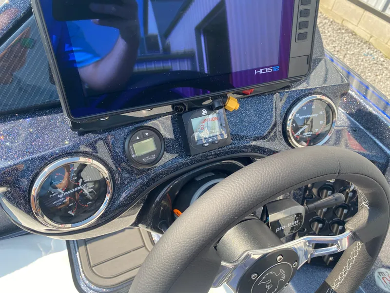 Slide: The Image of Dashboard of 2026 Phoenix 921 2 Elite X boat with steering wheel and digital displays. - 9