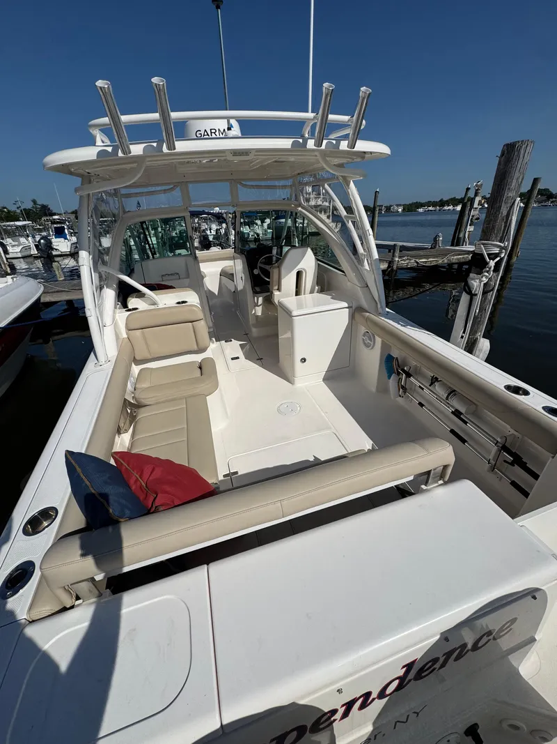 Slide: The Image of 2016 Pursuit DC 265 Dual Console boat docked, featuring spacious seating and sleek design. - 14