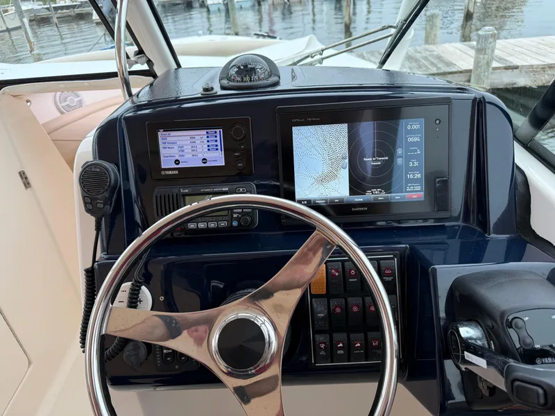 Slide: The Image of 2016 Pursuit DC 265 Dual Console boat dashboard with Garmin navigation and Yamaha controls. - 5