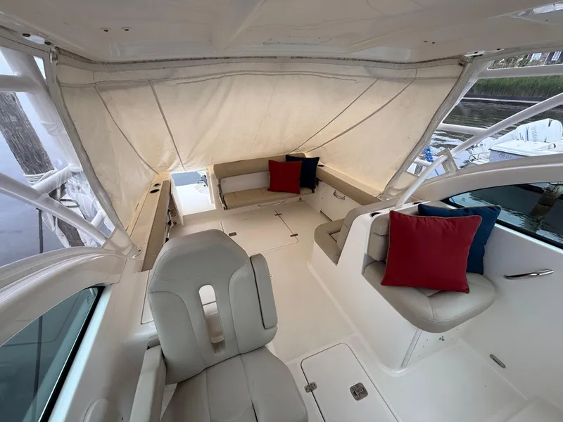 Slide: The Image of 2016 Pursuit DC 265 Dual Console boat interior with seating and colorful cushions. - 7