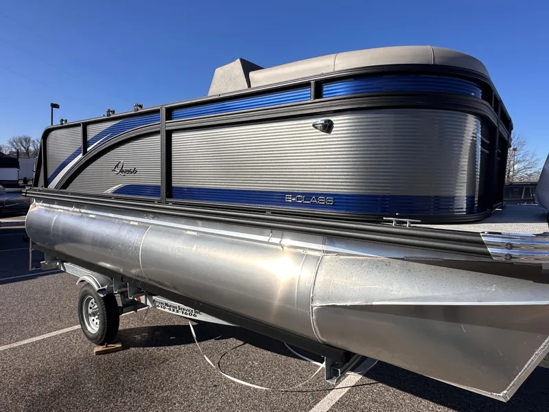 The Image of 2025 Qwest 8516 Lanai pontoon boat on trailer, featuring sleek blue and gray design. - 1