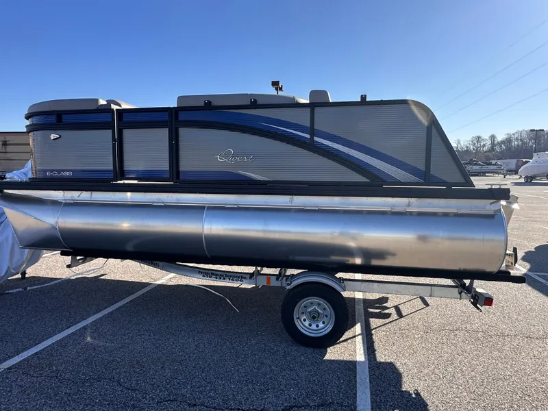 Slide: The Image of 2025 Qwest 8516 Lanai pontoon boat on trailer in parking lot. - 2