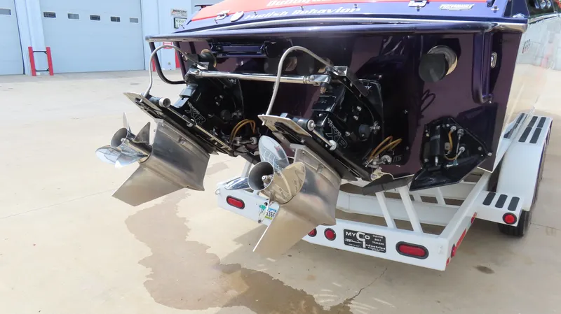 Slide: The Image of 2005 Cigarette 38 Top Gun boat on trailer, showing dual propellers and stern details. - 15