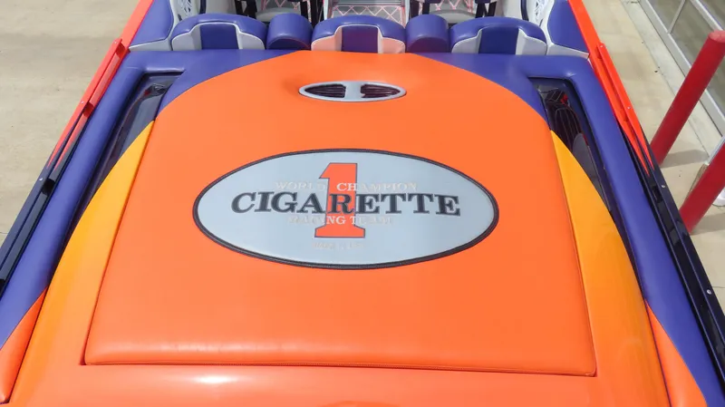 Slide: The Image of 2005 Cigarette 38 Top Gun boat with vibrant orange and blue design. - 19