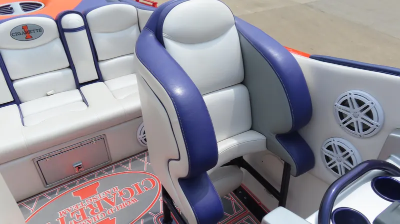 Slide: The Image of 2005 Cigarette 38 Top Gun boat interior with blue and white seating and speaker system. - 21