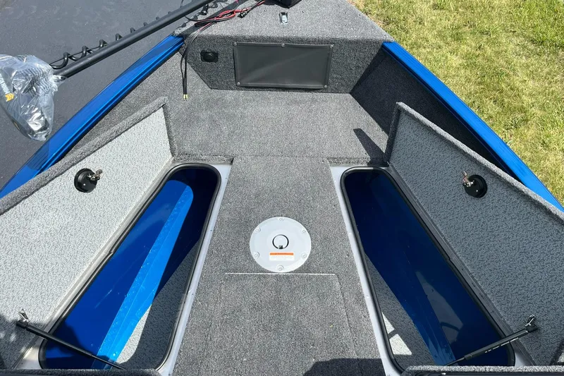 Slide: The Image of 2026 Lund 1775 Adventure Sport boat interior with open storage compartments. - 12