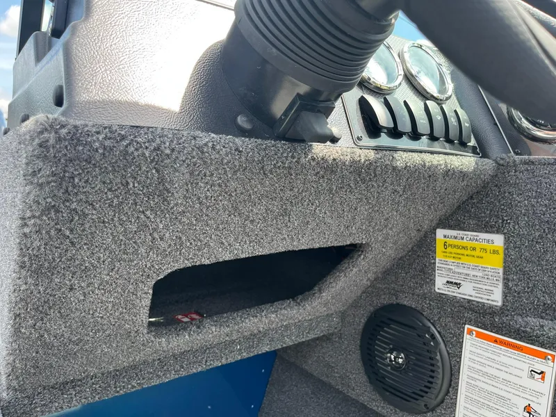 Slide: The Image of 2026 Lund 1775 Adventure Sport dashboard with controls and capacity warning label. - 19