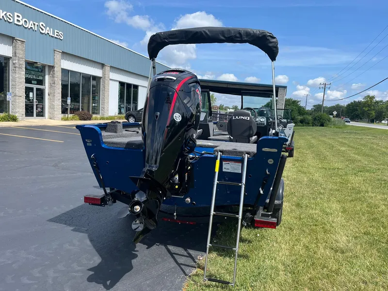 Slide: The Image of 2026 Lund 1775 Adventure Sport boat with outboard motor at dealership. - 2