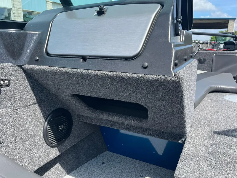 Slide: The Image of Interior of 2026 Lund 1775 Adventure Sport boat, featuring storage compartment and speaker. - 20