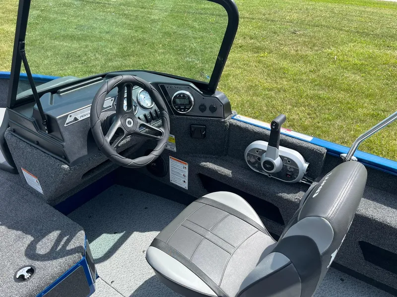 Slide: The Image of 2026 Lund 1775 Adventure Sport boat interior with steering wheel and control panel. - 7
