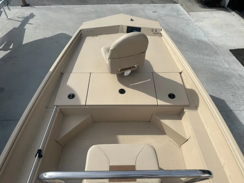 Slide: The Image of 2024 G3 Bay 17 boat interior with beige seating and storage compartments. - 10