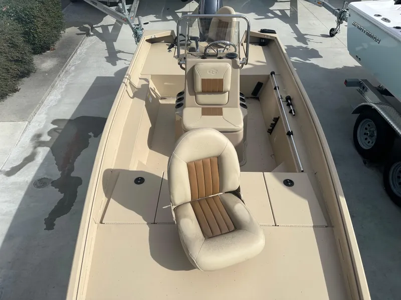 Slide: The Image of 2024 G3 Bay 17 boat with beige seating and console, parked on a trailer. - 11