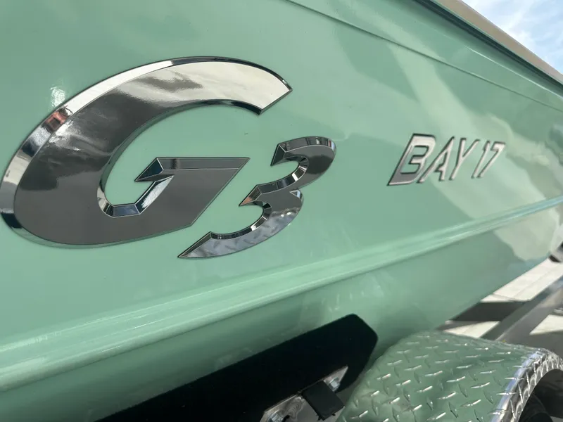 Slide: The Image of 2024 G3 Bay 17 boat with metallic logo on light green hull. - 14