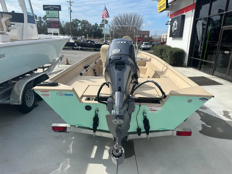 Slide: The Image of 2024 G3 Bay 17 boat with outboard motor, displayed at dealership. - 5