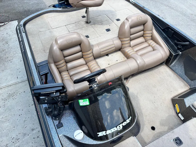 Slide: The Image of 2000 Ranger 518VX Comanche boat interior with beige leather seats and steering console. - 10