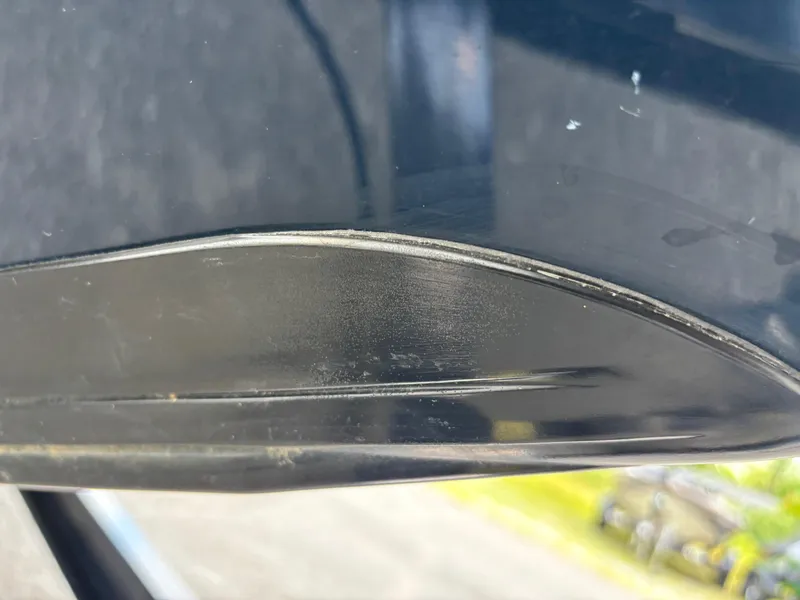 Slide: The Image of Close-up of a 2000 Ranger 518VX Comanche boat hull with visible wear. - 3