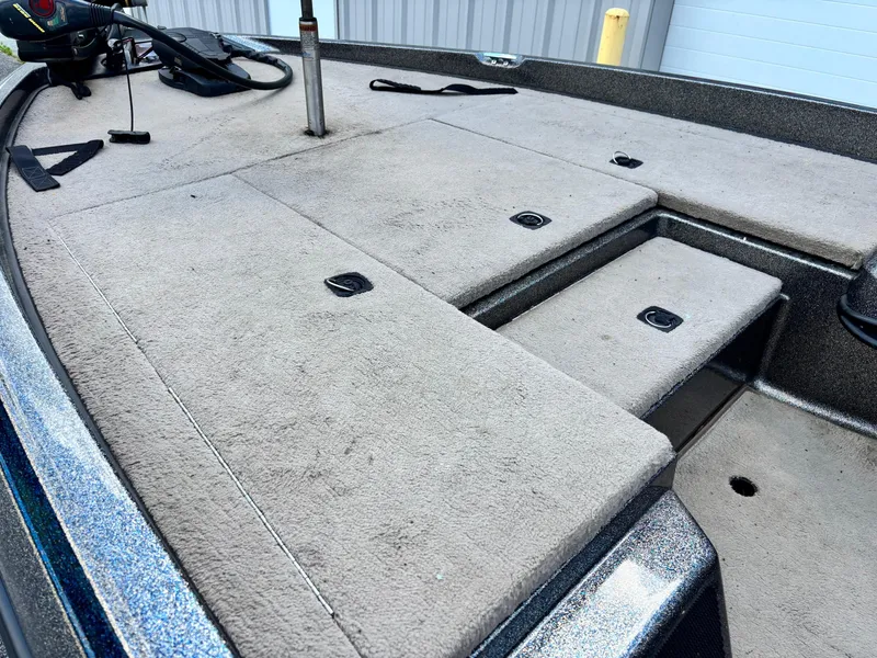 Slide: The Image of 2000 Ranger 518VX Comanche boat deck with carpeted surface and storage compartments. - 6